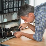 depositphotos_89551190-stock-photo-serviceman-working-on-fridge-at